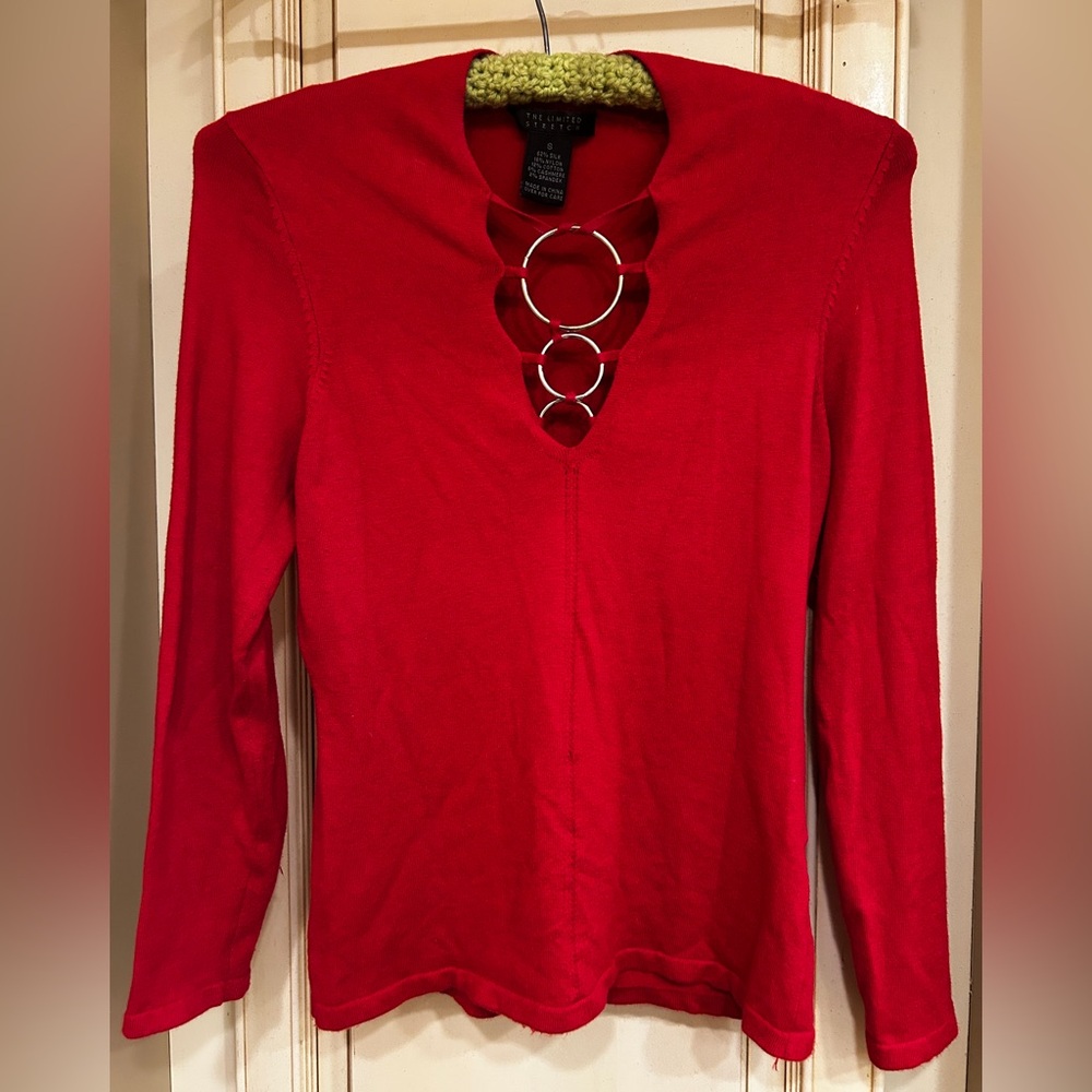 Red silk/nylon/cotton/cashmere/spandex top with v-neck & decorative metal hoops.